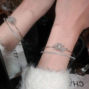 Detail of elegant double-layer cuff bracelet with zircon snowflake and crystal chain