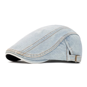 Detail of adjustable metal buckle and contrast stitching on denim newsboy hat