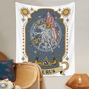Detail of Taurus zodiac tapestry with gold sun and star patterns in a cozy room