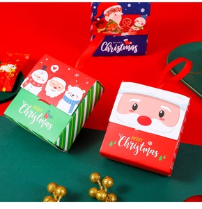 Three colorful Christmas gift boxes with ribbons featuring Santa, snowman, and bear patterns