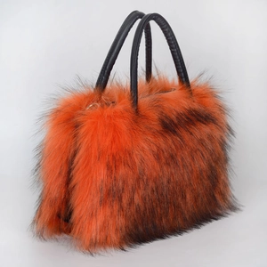 Detail of the orange and black gradient faux fur texture with black leather handle