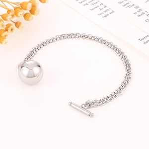 Detail of silver titanium steel bracelet with OT toggle clasp and spherical bead pendant