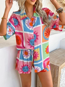 Detail of bohemian vacation set featuring colorful sun face prints on shirt and shorts
