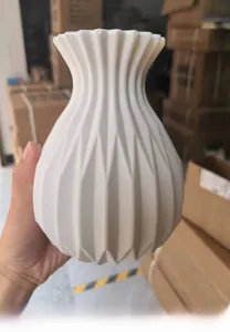 Detailed view of white geometric textured vase showing origami-style vertical patterns