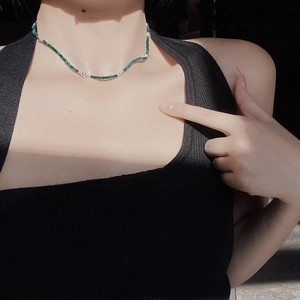 Detailed close-up of handmade S925 silver and deep green turquoise beaded choker necklace