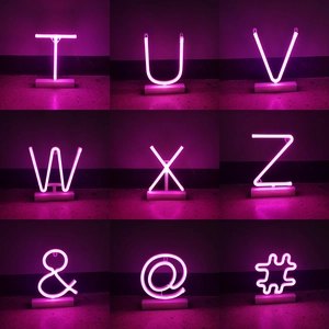 Pink LED neon letter lights on base for festive Christmas and bar ambient decoration