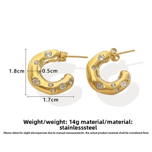 Detail view of 18k gold-plated C-shaped stainless steel earrings with cubic zirconia