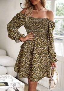 Detail of floral puff sleeve dress with elastic waist and ruffled hemline accents