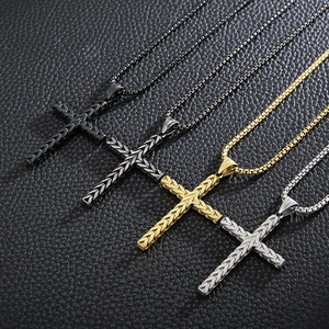 Detail of four stainless steel cross necklaces in black gold and silver with wheat pattern