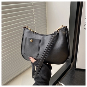 Close-up of black PU leather shoulder bag with gold hardware and snap button pocket