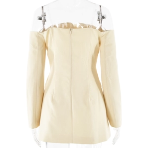 Detail view of the back zipper closure on this off-shoulder long sleeve beige bodycon dress