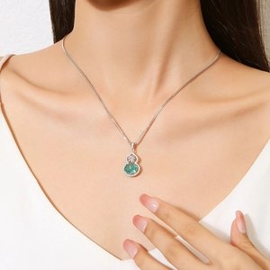 Elegant S925 silver gourd necklace with green emerald gemstone worn by model on collarbone