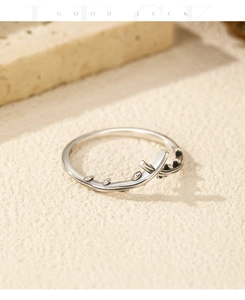 Close-up of S925 sterling silver vintage olive branch ring with cross design on stone base