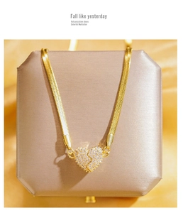 Detailed close-up of gold-plated heart pendant necklace with micro-pave crystals