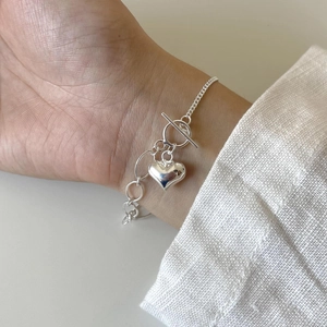 Minimalist S925 sterling silver heart bracelet with OT buckle on a woman's wrist