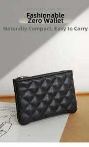 Close-up of black quilted PU leather coin purse with silver zipper on a modern surface