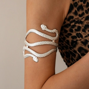 Silver metallic double-headed snake arm cuff with detailed scale texture on the model