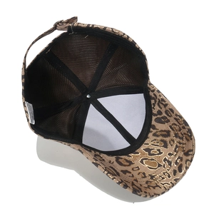Detail of baseball cap interior showing gold leopard print fabric and adjustable strap