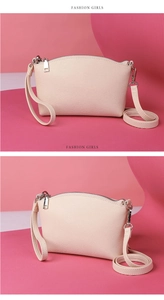 Detailed view of cream white crossbody bag with lychee texture and silver zippers