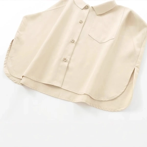 Minimalist apricot twill blouse with lapel collar, single chest pocket and curved hemline