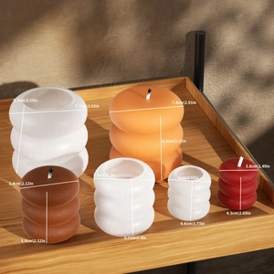 Stacked bubble candle dimensions showing various sizes and warm colors on wooden shelf