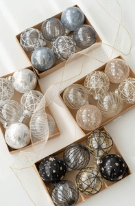 Detailed view of 8cm assorted Christmas balls with glitter patterns in kraft gift boxes