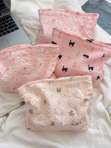 Quilted floral cartoon makeup bags with rabbit and cat patterns on white sheet