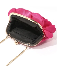 Detailed interior of fuchsia satin rose evening clutch with gold chain and metal frame