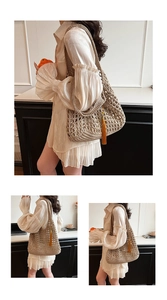 Detail of hand-woven crochet tote bag with mesh pattern and vibrant orange tassel accent
