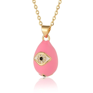 Detail of gold evil eye pendant with pink enamel and sparkling white zircon stones