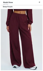 Detail of dark purple high-waisted wide-leg sports trousers with an elastic waistband