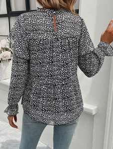 Detail view of floral long sleeve blouse with elegant back keyhole button and ruffle trim