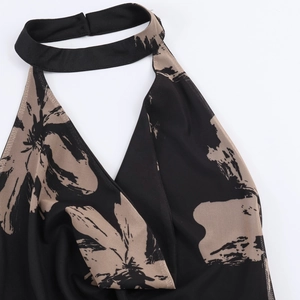Sleeveless halter neck midi dress with beige floral print on black stretch fabric