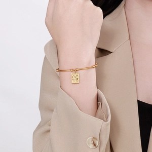 Elegant gold stainless steel bead bracelet featuring a rectangular moon and star charm