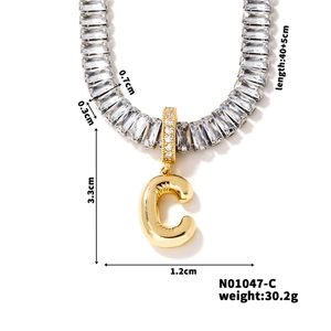 Detail of cubic zirconia square link chain with golden balloon letter C pendant