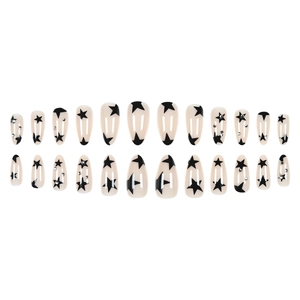 Almond shaped press-on nails in nude with black stars and small rhinestone accents