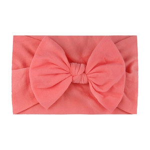 Coral red soft nylon headband with large bow for baby girls, stretch knit hair accessory