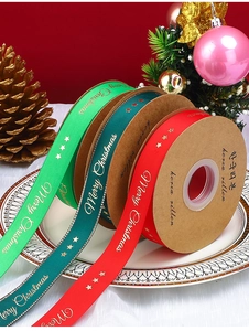 Detail of Christmas ribbons in red and green with gold Merry Christmas print and pine cones