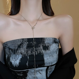 Silver Y-shaped twisted knot necklace showcased on a model with minimalist metal design