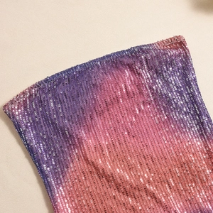 Close-up of gradient purple and pink sequins on a strapless dress with metallic shine