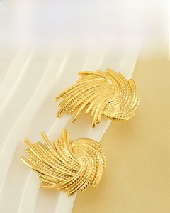 Detail of 18K gold-plated irregular swirl earrings with delicate grainy metal texture