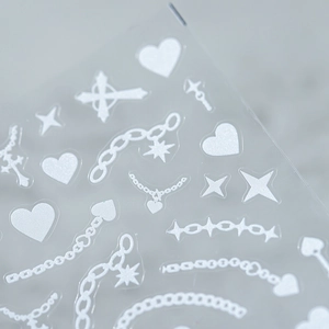 White cyber punk nail stickers with heart star and chain patterns on stone background