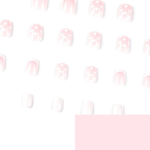 Pink and white press-on nails with heart patterns and classic French tip design