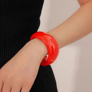 Irregular vibrant red wavy wide cuff bracelet in polished acrylic on model wrist