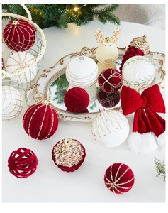 Close-up of velvet Christmas ornaments with gold embroidery and champagne reindeer baubles
