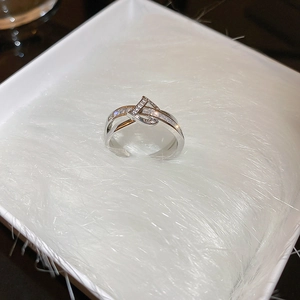 Macro detail of silver double-layered ring with zircon stones in white jewelry box