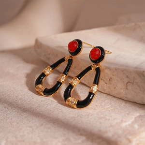 Vintage gold-plated drop earrings with red round stones and black enamel dripping
