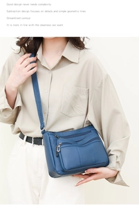 Blue faux leather crossbody bag featuring multiple zipper pockets and adjustable strap