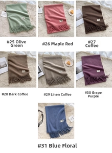 Detailed close-up showing a variety of solid color tassels and soft cashmere-feel scarves