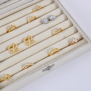 Elegant beige velvet jewelry storage box with glass lid for rings and earrings display